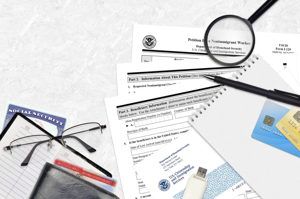 USCIS form I-129 Petition for a nonimmigrant worker lies on flat lay office table and ready to fill